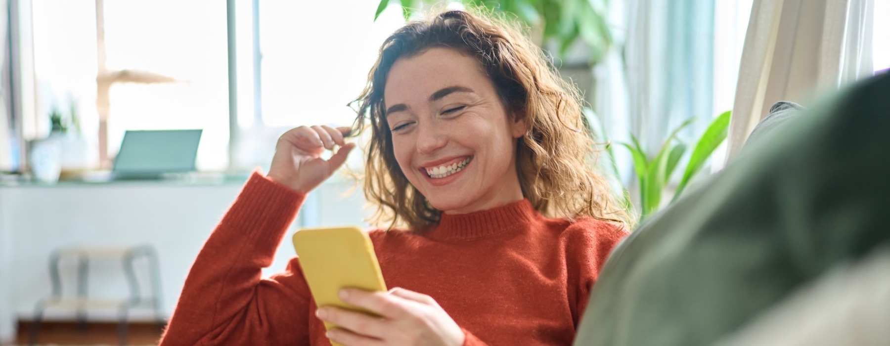 a woman on her phone in a well-lit room