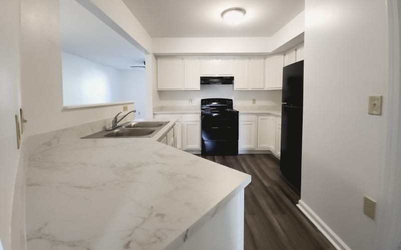 a kitchen with a sink and a bed